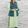 Woman wearing a sleeveless teal jacket with embroidered leaf motifs, crepe lining, and front pockets, styled over a light green kurta.