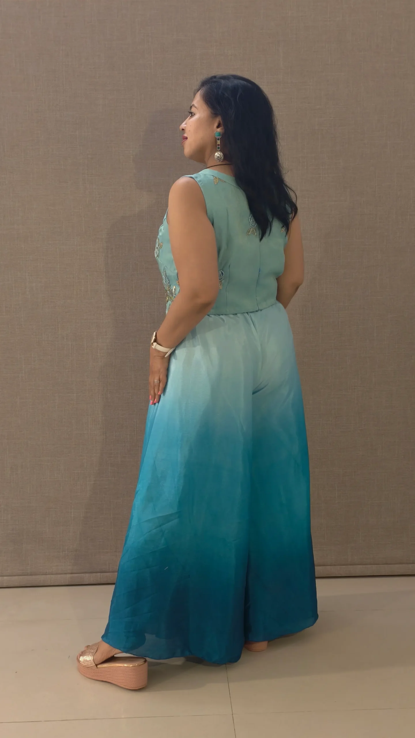 Model wearing peacock blue ombre satin co-ord set with hand-embroidered crop