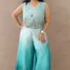 Model wearing peacock blue ombre satin co-ord set with hand-embroidered crop