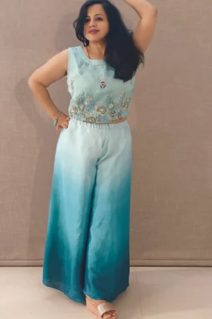 Model wearing peacock blue ombre satin co-ord set with hand-embroidered crop