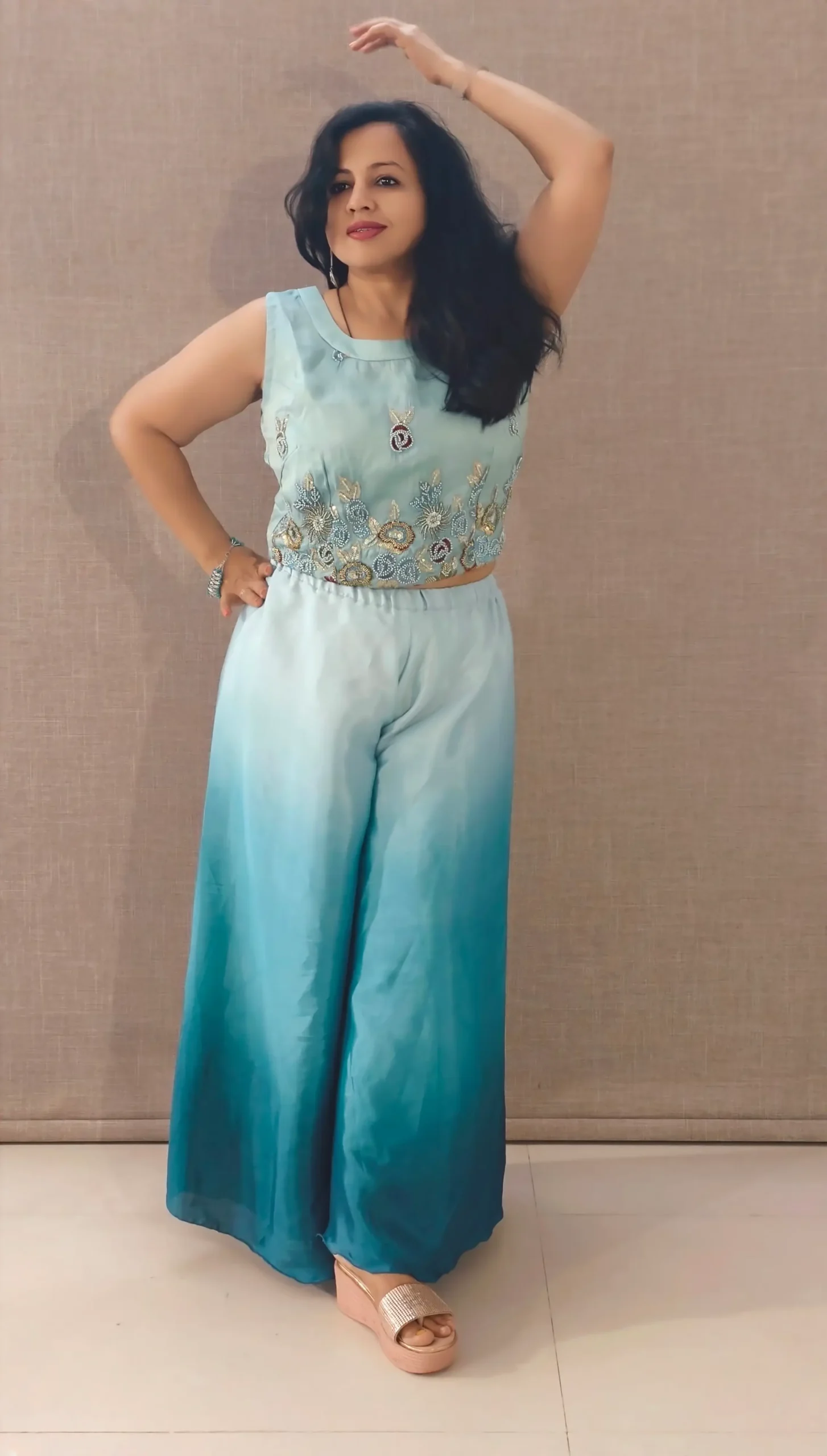 Model wearing peacock blue ombre satin co-ord set with hand-embroidered crop