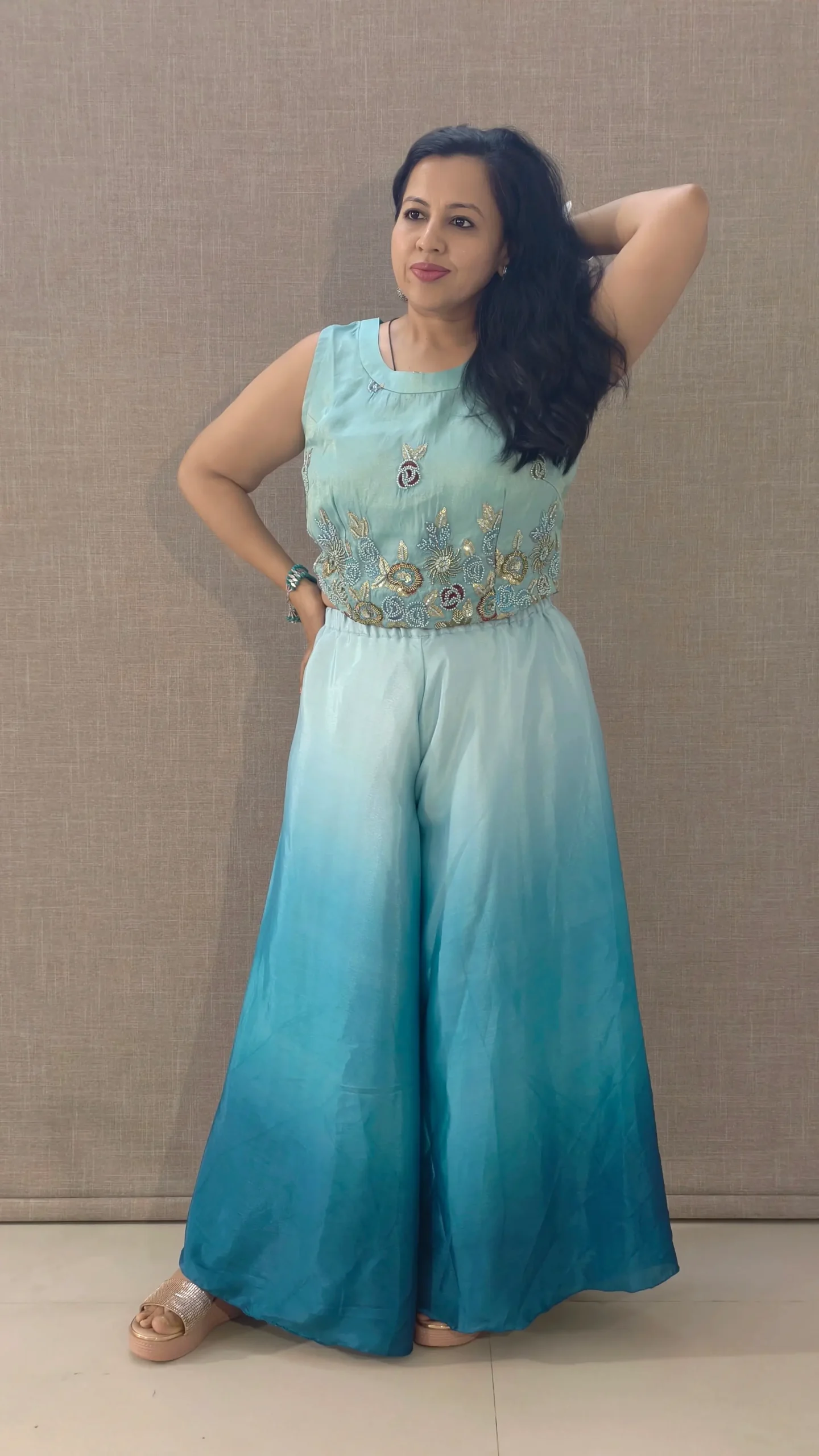 Model wearing peacock blue ombre satin co-ord set with hand-embroidered crop